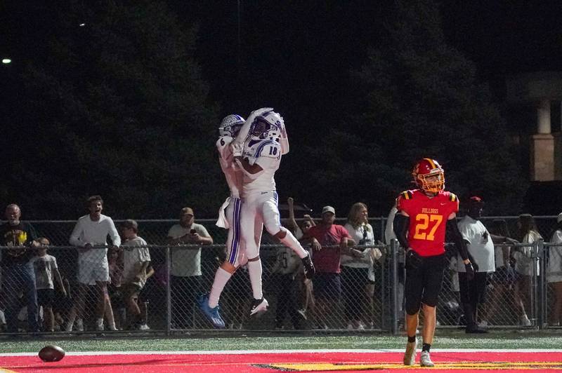 St. Charles North's Keaton Reinke (6) celebrates with Christopher Akpede (18) after scoring a touchdown against Batavia during a football game at Batavia High School on Friday, Sep 20, 2024.