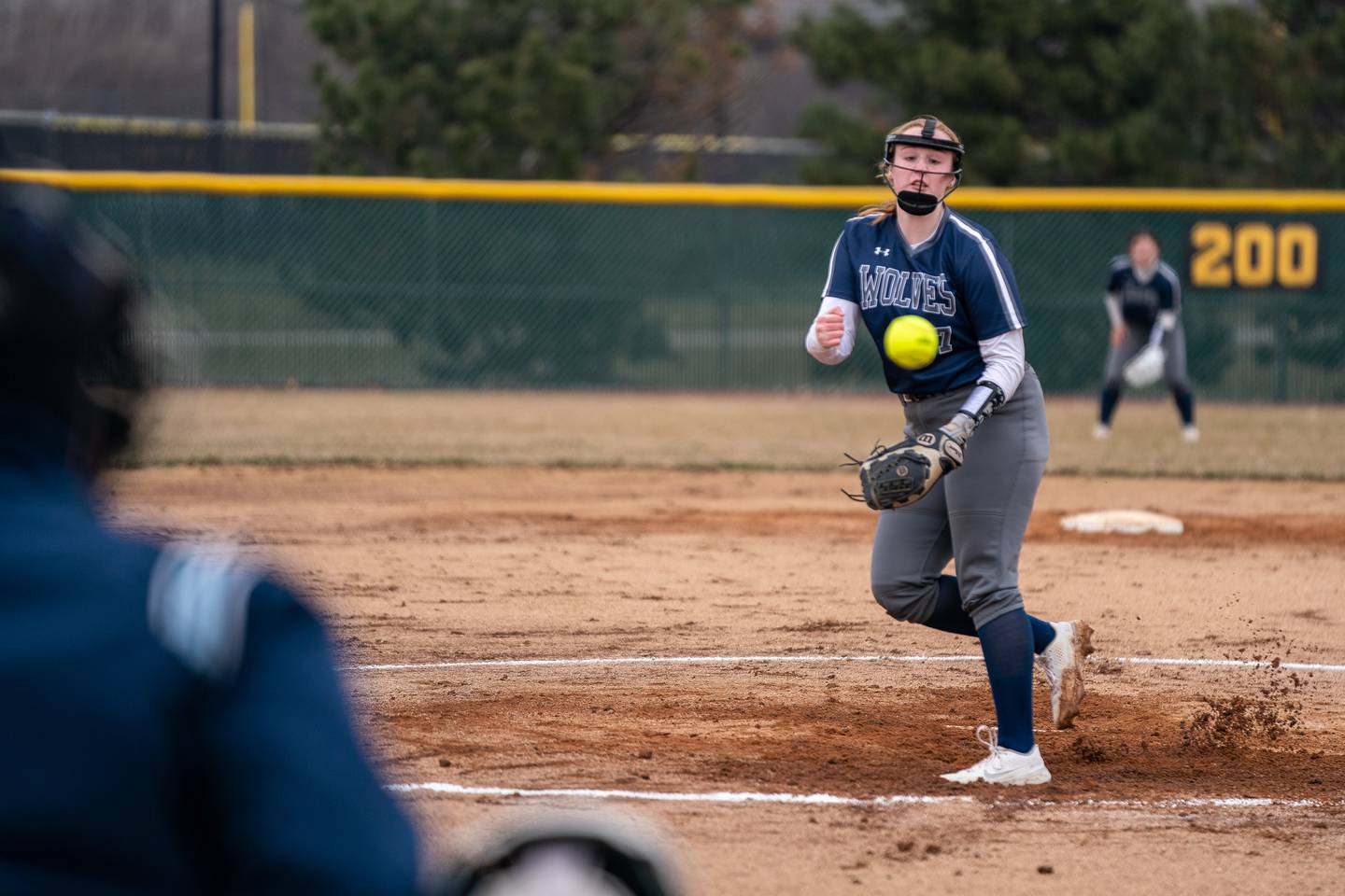 Oswego East's Emma LenczewskI (7) delivers a pitch against Metea Valley during a softball game at Metea Valley High School in Aurora on Friday, Mar 24, 2023.