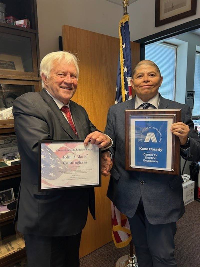 Kane County Clerk John A. Cunningham (left) congratulating his Director of Elections, Raymond Esquivel on Oct. 23, 2025.