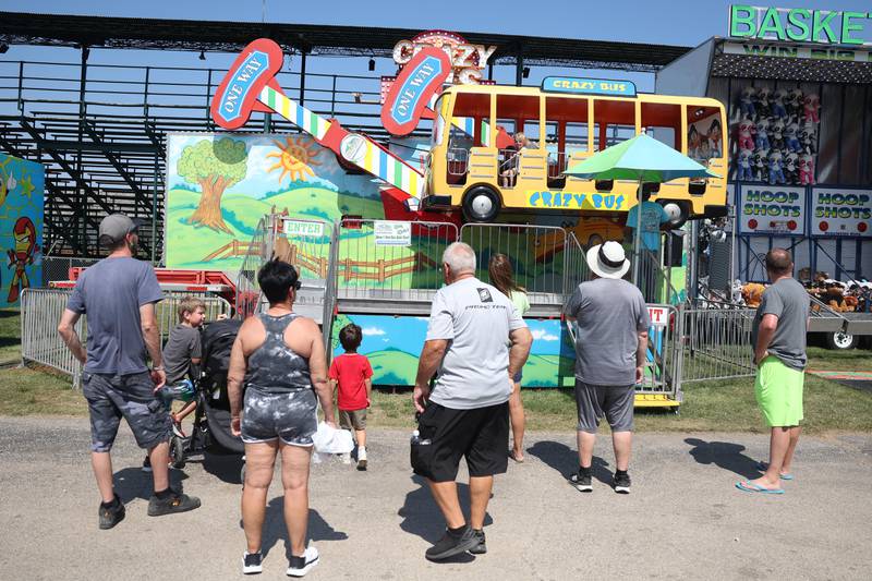 Families enjoy the Crazy Bus ride at the Will County Fair on Sunday, August 25, 2024 in Peotone.