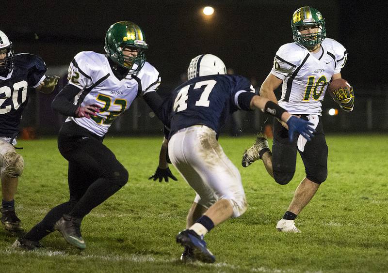 Crystal Lake South senior Austin Rogers (right) runs the ball toward Cary-Grove senior Jack Timmins (47) during the fourth quarter last season in Cary. Cary-Grove won, 21-14. The rivals face each other again Friday at South.