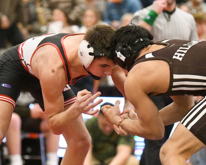 Vincent Konecki, left, of Yorkville keeps a hold of Aurelio Munoz of Joliet Catholic Academy during the 132-weight class regional meet held on Tuesday Feb. 25, 2025, held at Yorkville High School.