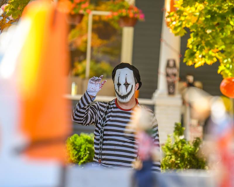 William Becker of Sycamore waves as floats pass by during the Pumpkin Parade on Sunday Oct. 28, 2024, downtown at the 63rd annual Sycamore Pumpkin Festival.