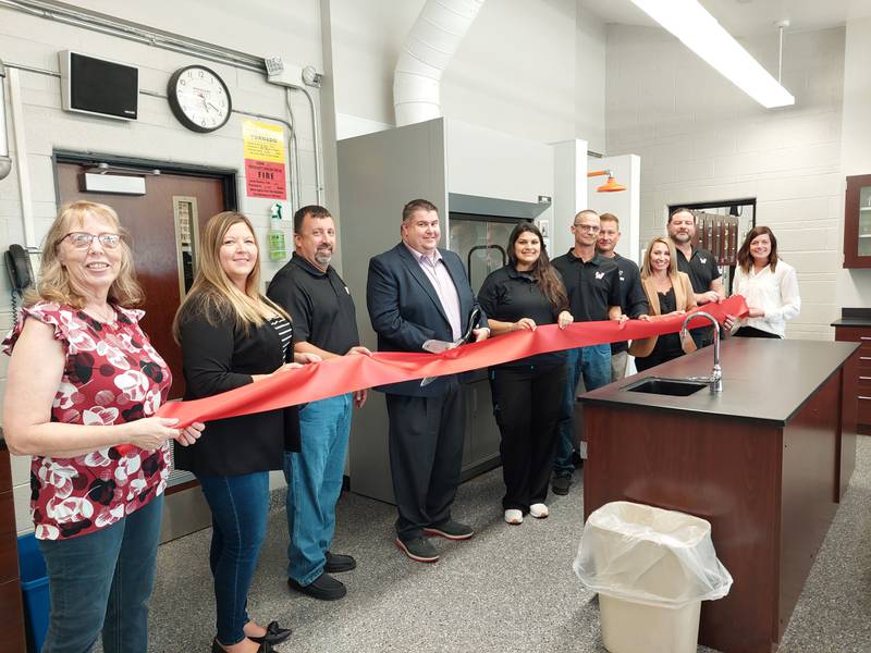 (From left) Judy Booze, of the Streator Chamber; Dana Stillwell, of the Streator Chamber; Eric Sass, Woodland School Board president; Superintendent Ryan McGuckin; Rebecca Sterling, Woodland School Board; Chad Gilkerson, Woodland School Board; Jeremy Adams, Woodland School Board; Alison Wissen, Woodland School Board; Eric Perhach, Woodland School Board; and Courtney Levy, Streator Chamber executive director, cut a ceremonial ribbon Tuesday, Sept. 19, 2023, for Woodland's new science lab.