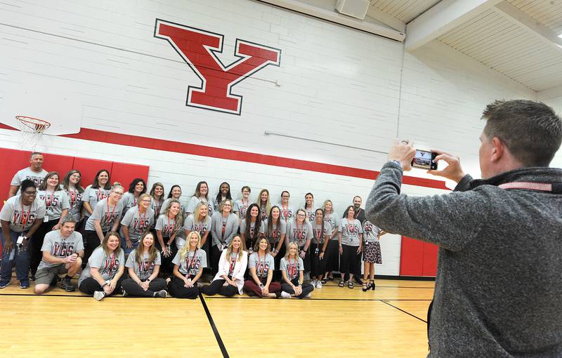 Brent Edwards, Director of Communications, takes a staff picture in the gym with a new floor on the first day of classes at Yorkville Grade School on Friday, Aug. 15, 2024.