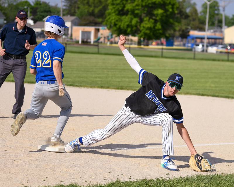 Newark's Payton Wills (15) stretches out to save the ball from getting past him while keeping his foot on the back to get Somonauk's Brady Andrews (22) out at first during the game on Tuesday May 13, 2025, held at Somonauk High School.
