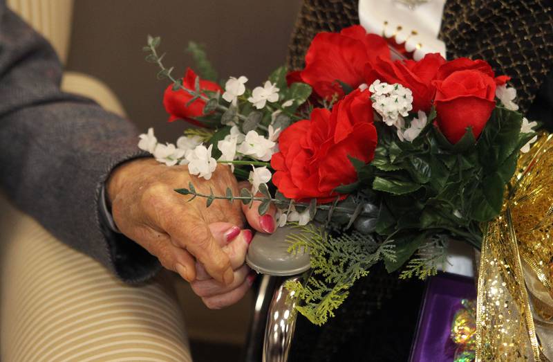 Bob and Vivian Anderson hold hands after they were crowned Prom King & Queen during the Senior Prom to celebrate the 50th Anniversary of Leisure Village in Fox Lake. The couple have been married for seventy-one years.