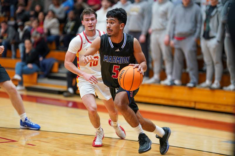 Marmion's Ali Muhammed Tharwani (5) drives the baseline against Batavia’s Joseph Reid (10) during a game at Batavia High School on Wednesday, Nov. 26, 2025.