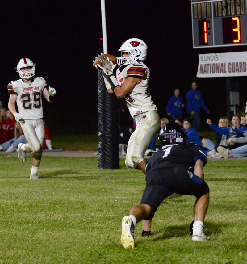 Forreston's Mickey Probst (24) catches a pass for points against Eastland-Pearl City defenders on Friday, Sept. 20, 2024 in NUIC Conference action in Pearl City.