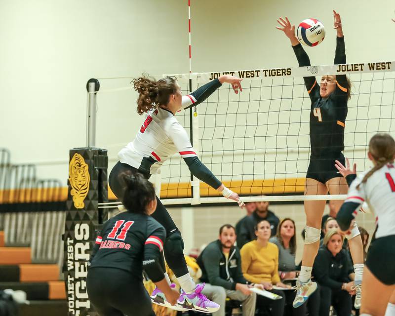 Bolingbrook's Noelle Aprati (9) hits the ball over the net during regional final volleyball match between Bolingbrook at Joliet West.  Oct 26, 2023.