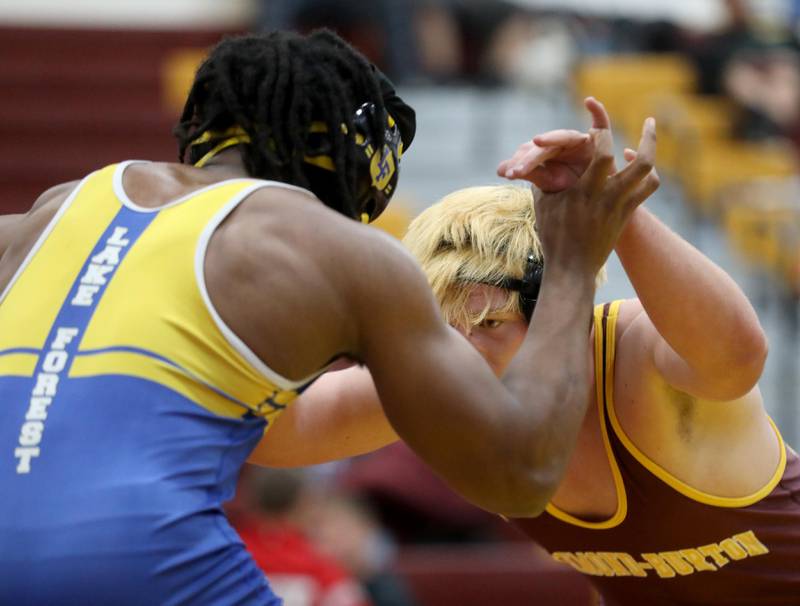 Richmond-Burton’s Shane Falasca (right) tries to takes down Lake Forest’s Yaree Sandifer during a 215-pound match in the Tom DuBois Invite wrestling meet on Saturday, Dec. 13, 2025, at Richmond-Burton High School in Richmond.