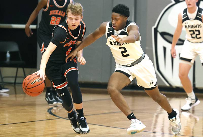 DeKalb's Sean Reynolds and Kaneland's Gevon Grant go after a loose ball during their game Tuesday, Jan. 24, 2023, at Kaneland High School.