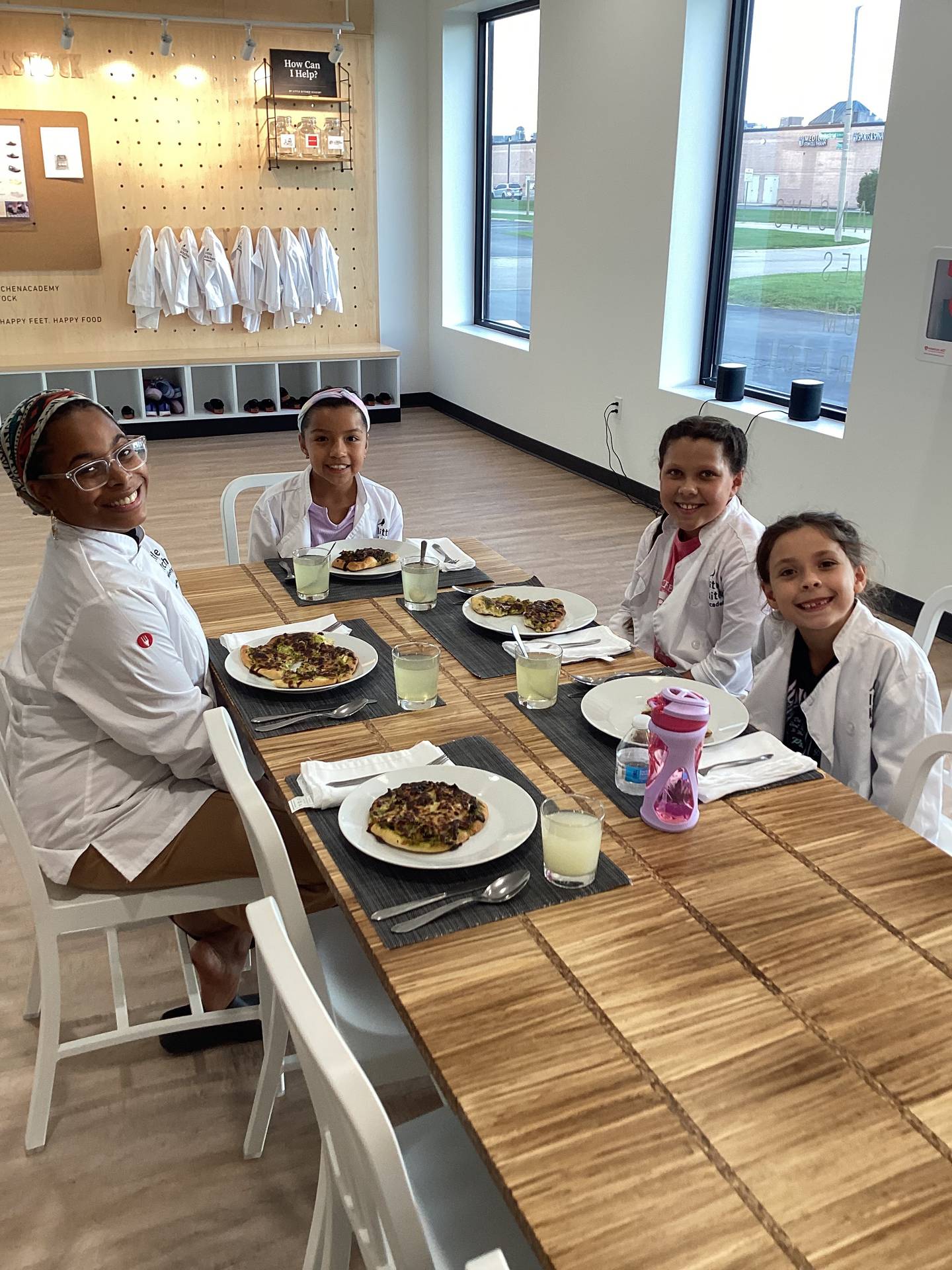 At the end of each Little Kitchen Academy class, a community table is set by the class participants and the kids eat what they made together.