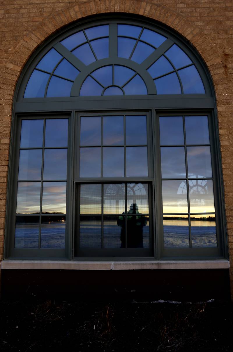 A person is reflected on Wednesday, Jan. 8, 2025, in the window of the building at Crystal Lake’s Main Beach.