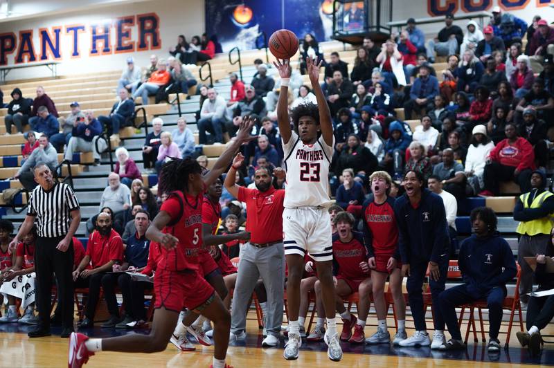 Oswego’s Dasean Patton (23) shoots a three pointer against West Aurora's Terrence Smith (5) during a basketball game at Oswego High School on Friday, Dec 1, 2023.