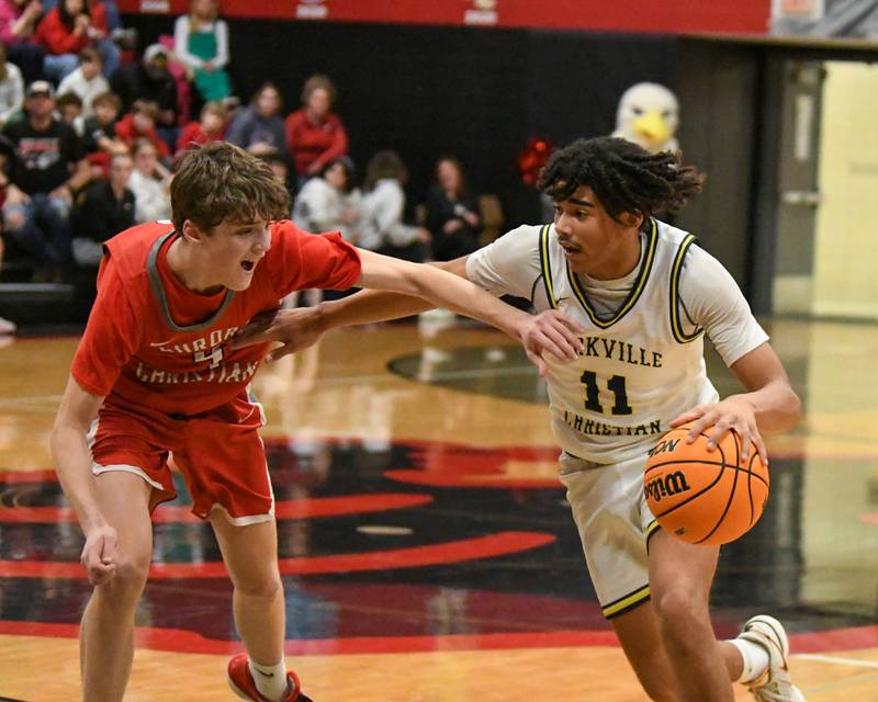 Yorkville Christian's Kayden Maxwell (11) tries to get around Aurora Christian's Joe DeCort (4) during the regional title game on Friday Feb. 28, 2025, held at Indian Creek High School.