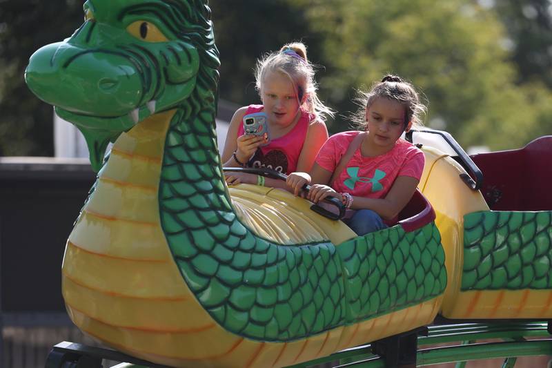 A couple friends ride a rollercoaster at the Saint Dennis and Joseph Catholic Academy Annual Oktoberfest on Saturday, Oct. 5, 2024 in Lockport.