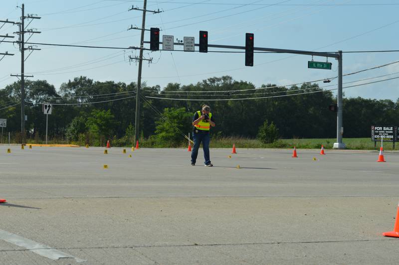 Investigators with the McHenry Police Department spent hours taking photos and gathering evidence at the intersection of Illinois Route 31 and Bull Valley Road on Sunday, Aug. 29, 2021.