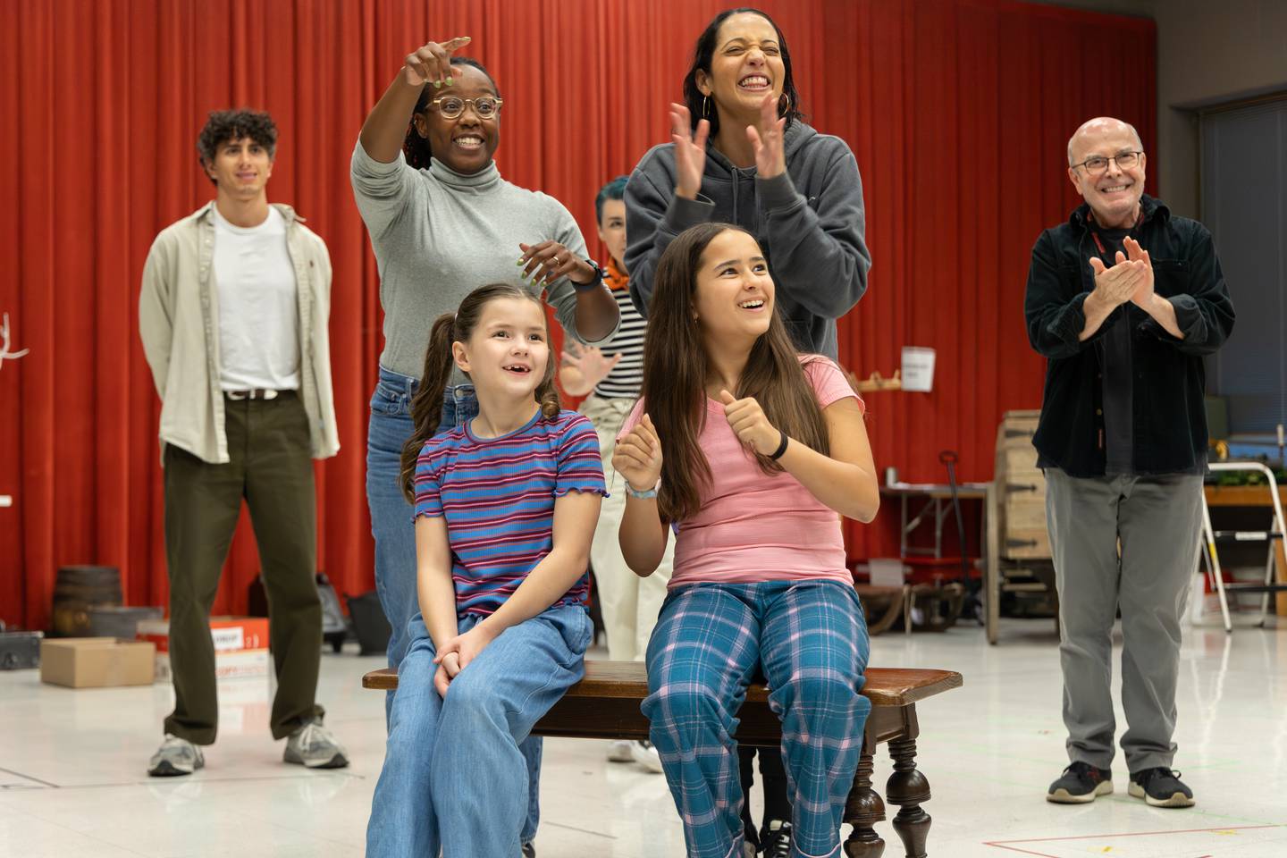 Ava Rose Doty of Downers Grove (Tiny Tim, seated left) rehearses with cast of the 2024 main-stage production of "A Christmas Carol" at Goodman Theatre in Chicago.