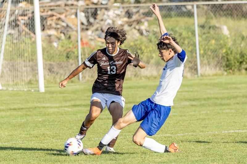 Joliet Catholic's Louis Czerkies and Joliet Central's Sebastian Duque fight for control of the ball during a varsity soccer game at Joliet Catholic on Sept. 8, 2025.