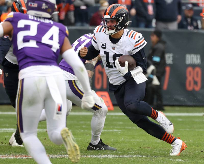 Chicago Bears quarterback Caleb Williams runs through a hole in the Minnesota Vikings defense during their game Sunday, Nov. 24, 2024, at Soldier Field in Chicago.