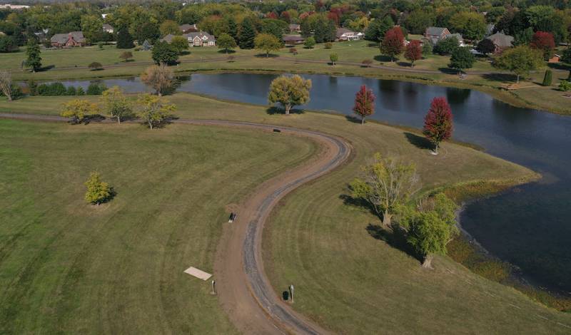 An aerial view of the walking path around Baker Lake on Monday, Oct. 13, 2025 in Peru. Crews are replacing the old walking path with a new one. The Peru City Council approved of the project last month. Gillan Construction out of Cherry was the winning bid to do the project for just under $300,000. The city will use a credit from Mertel Gravel of about $200,000 to pay for materials.

The resurfacing work will include a 10-foot wide concrete path with secondary concrete paths also added, connecting with the new parking lot near Lighted Way and connecting with the parking lot, playground, and shelter on the west side of Baker Lake. The park is closed to the public until early December.