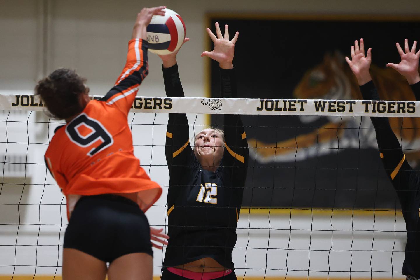 Joliet West’s Brooke Schwall blocks a shot resulting in a point against Lincoln-Way West on Tuesday, Sept. 12, in Joliet.