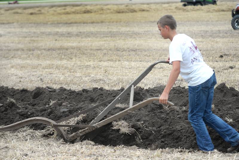 Bennett Sierens, 15, of Annawan, uses a John Deere hand plow at the Bos Brothers Historical Farm south of Erie on Friday, July 25, 2025.