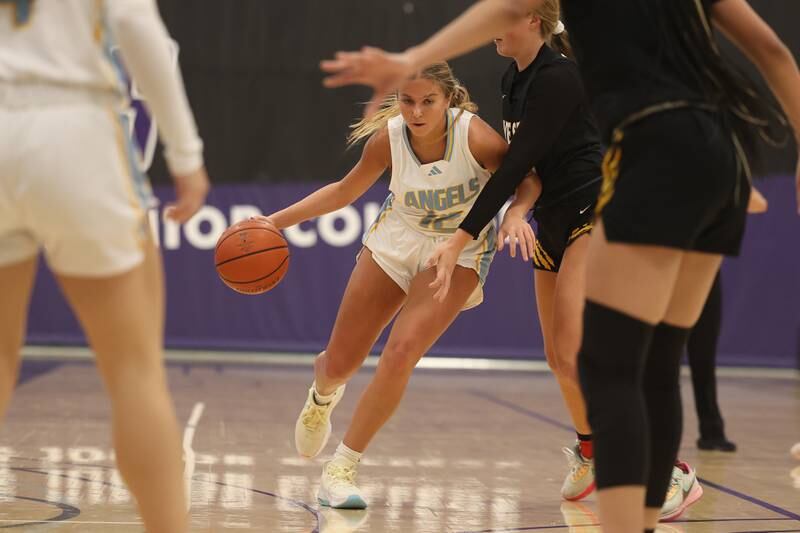 Joliet Catholic’s Sophia Mihelich makes a drive against Joliet West in the 2023 WJOL Girls Basketball Tournament on Friday, Nov. 17, 2023, in Joliet
