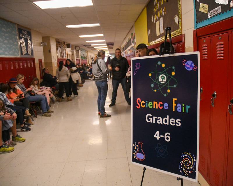 Parents wait in the hallway at O’Neill MIddle School in Downers Grove as students science projects get judged on Saturday Jan. 25, 2025, during the Downers Grove  District 58 science fair.