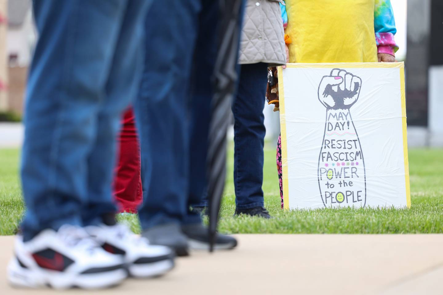 A protest sign reflects the May Day message during the May Day Strong rally at the Kankakee County Courthouse on May 1, 2026, as part of a national day of action.
