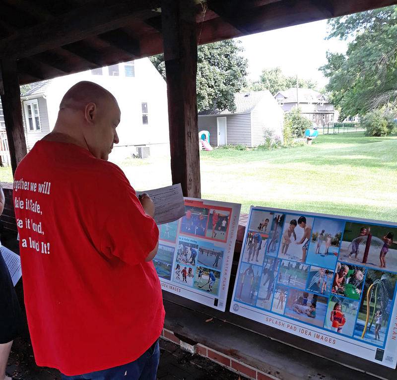 A resident scans designs as he fills out a survey during an open house at Thornton Park. Results of the survey will help the city make a master plan for the park.