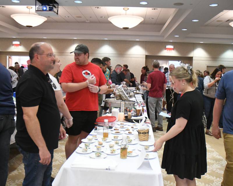A row of tables is ready to share a variety of food dishes during the 20th anniversary of 50 Men Who Cook, an annual fundraiser hosted by CASA DeKalb County at the Barsema Alumni and Visitors Center at Northern Illinois University in DeKalb on Saturday, Aug. 10, 2024.