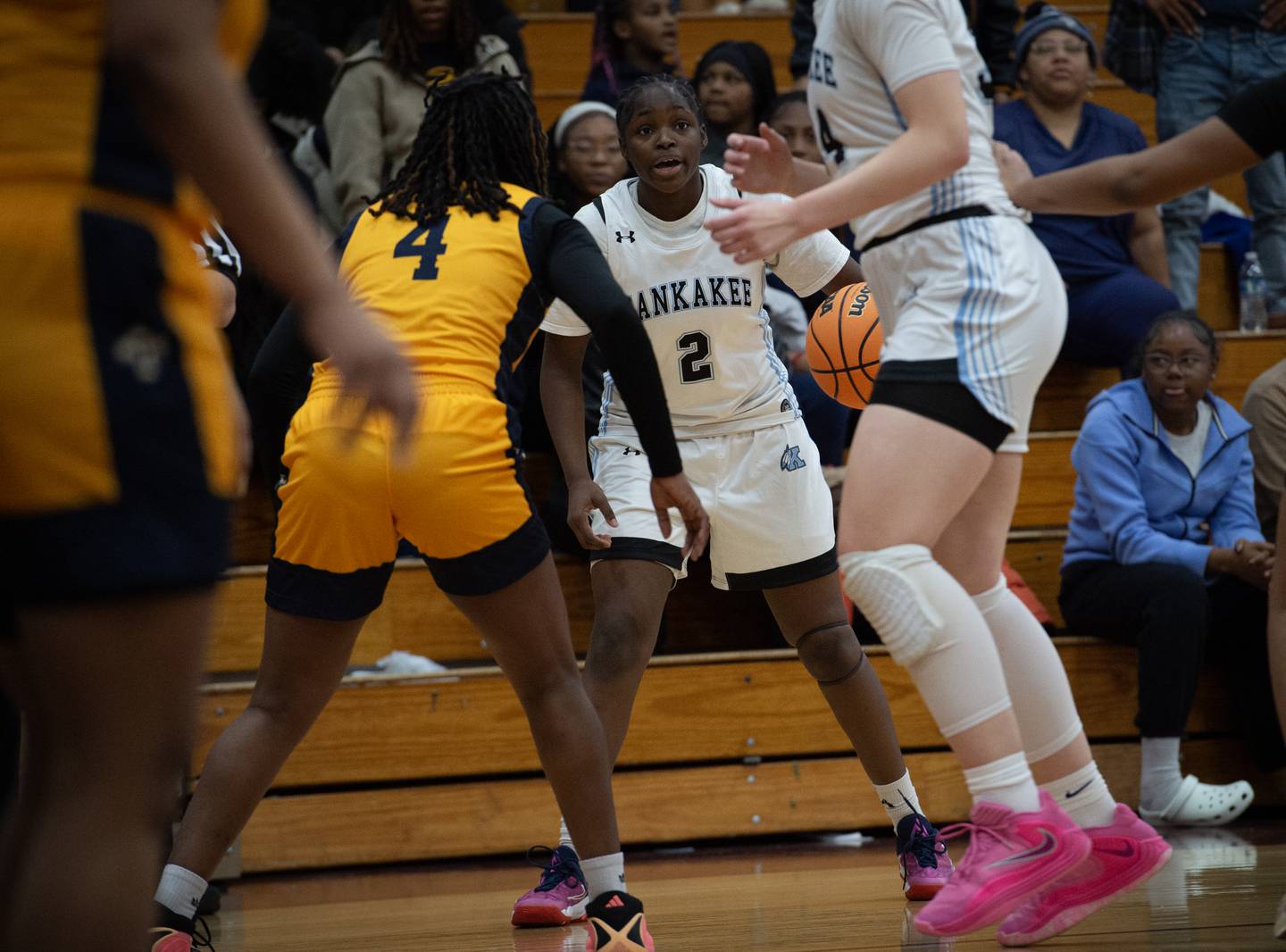 Kankakee's London Stroud, center, controls the ball as Thornwood's Nasiyah Baker defends in a game on Thursday, December 11, 2025.