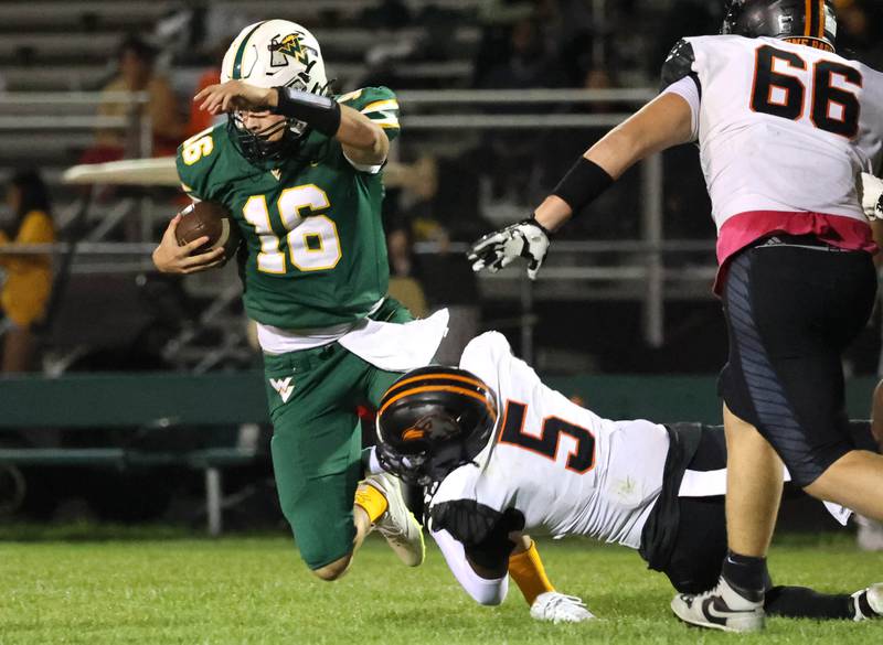 Waubonsie Valley’s Colin Ford is sacked by DeKalb's Pierre Cathina during their game Friday, Oct. 11, 2024, at Waubonsie Valley High School in Aurora.