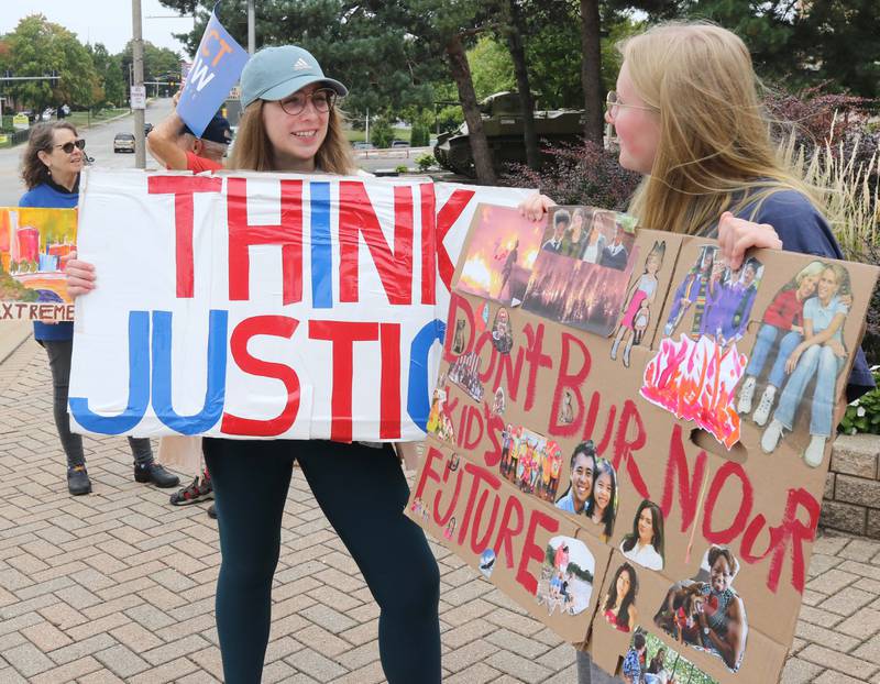 Darby McGowan, from DeKalb, and Carissa Bos, from Sycamore, chat during a rally Saturday, Sept. 16, 2023, at Memorial Park in downtown DeKalb. The demonstration was held to push legislators to promote alternative forms of energy and lessen the use of fossil fuels.