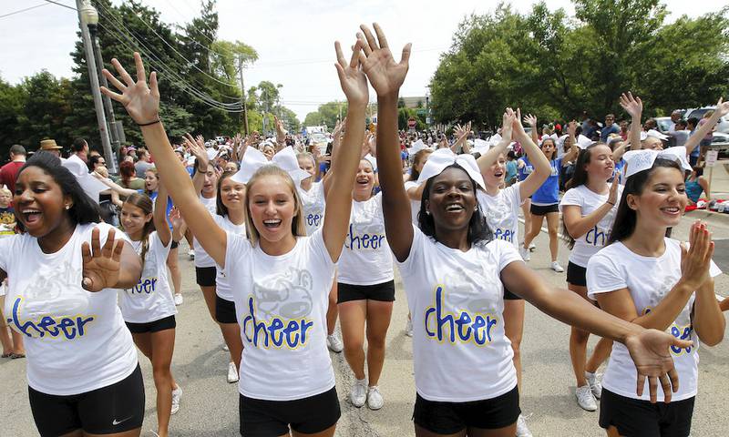 Warren Township High School cheerleaders make their way down Old Grand Avenue during the Gurnee Days Parade on Sunday.