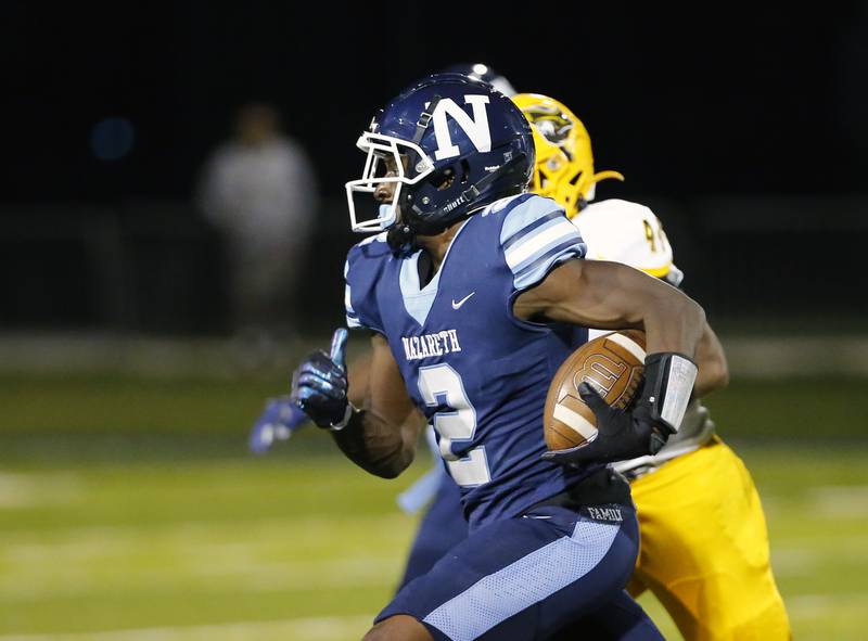 Nazareth Academy's Justin Taylor (2) runs the ball during the varsity football game between Carmel Catholic and Nazareth Academy on Friday, September 24, 2021 at Nazareth Academy in LaGrange Park, IL.