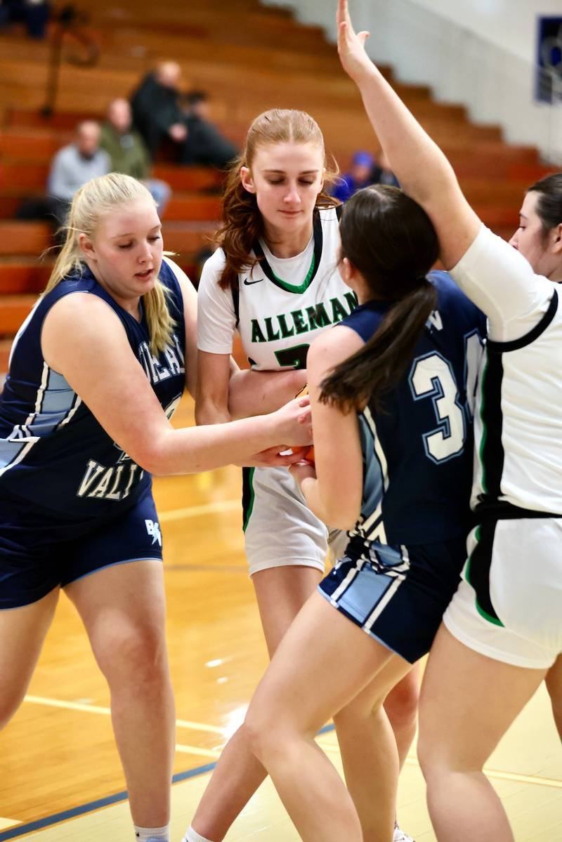 Bureau Valley's Emma Stull (left) and Brynley Doty battle Alleman's Adalyn Voss for a rebound in regional semifinal play Tuesday at Princeton.