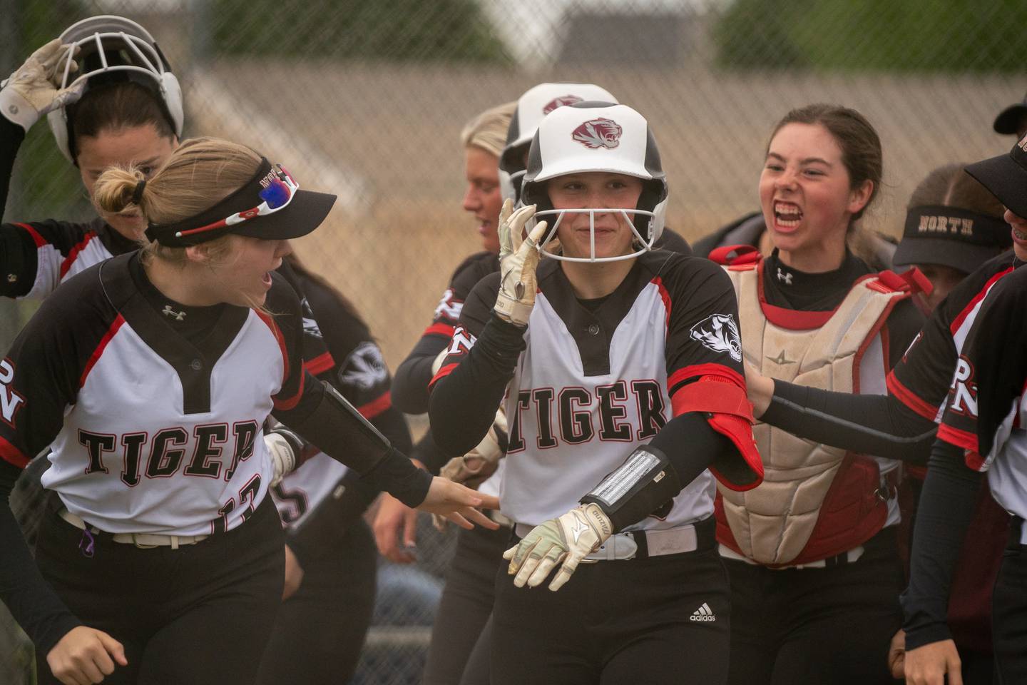 Plainfield North's Alexandra Sikora (6) is greeted by her team mates after hitting a two run homer to tie the game against Yorkville during the Class 4A Oswego East Regional softball final at Oswego East High School on Friday, May 27, 2022.