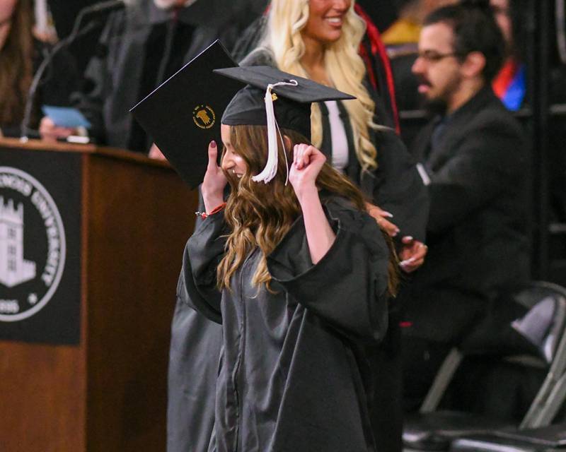 A Northern Illinois University graduate celebrates after receiving her diploma on Saturday May 9, 2026, held at the Convocation Center in DeKalb.