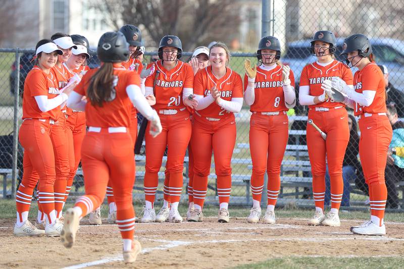 Lincoln-Way West’s Reese Cusack is greeted at home by her teammate after a home run against Plainfield South on Tuesday, March 24, 2026 in Plainfield.