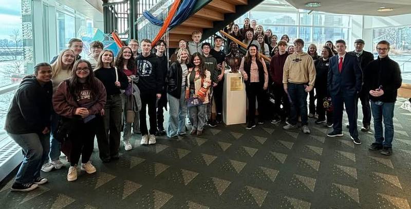 Princeton Christian Academy students gather around the bust of Shakespeare in the theater lobby of the Chicago Shakespeare Theater.