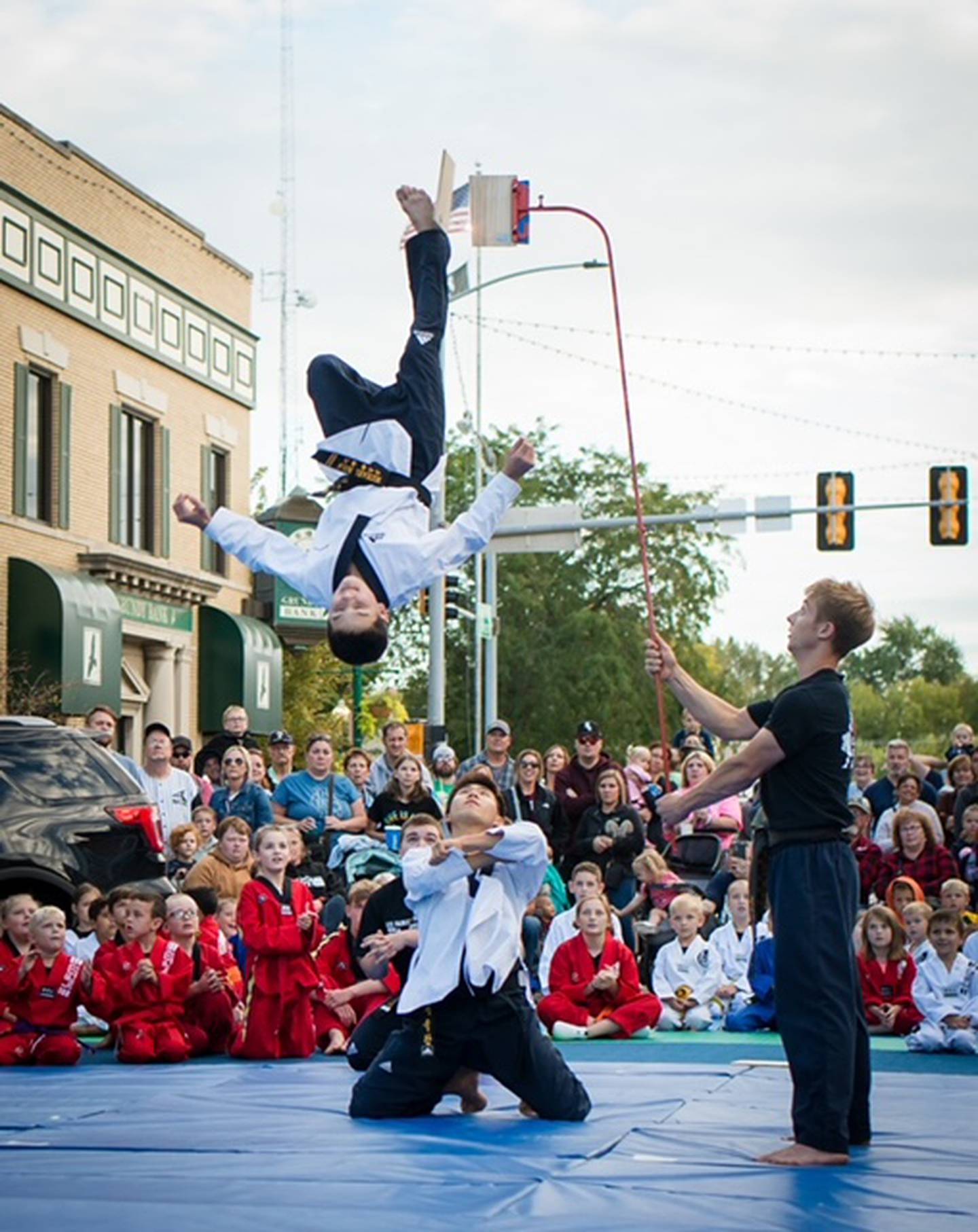 Michael Bolis flips in the air as part of a performance with Lee Family Martial Arts
