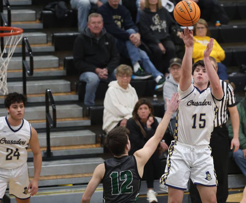 Marquette's Alec Novotney shoots a jump shot over Midland's Caleb Dorsey during the Tri-County Conference Tournament on Monday, Jan. 26, 2026 at Putnam County High School