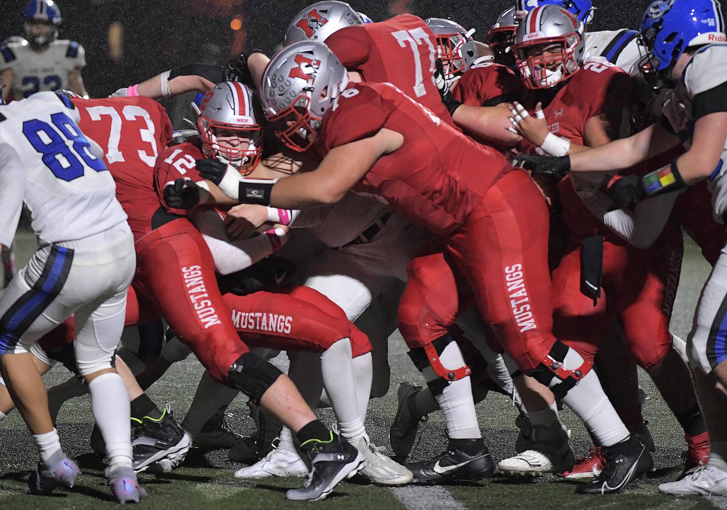 Mundelein’s Danny McNelly crosses the goal line with help from his offensive line in a football game against Lake Zurich in Mundelein on Friday, October 13, 2023.