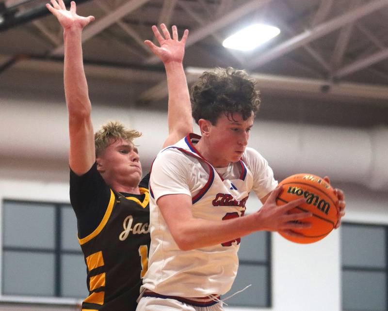 Dundee-Crown’s Hudson Reardon, right, snags a rebound in front of Jacobs’ Carson Goehring in varsity boys basketball on Friday, Dec. 12, 2025, at Dundee-Crown High School in Carpentersville.