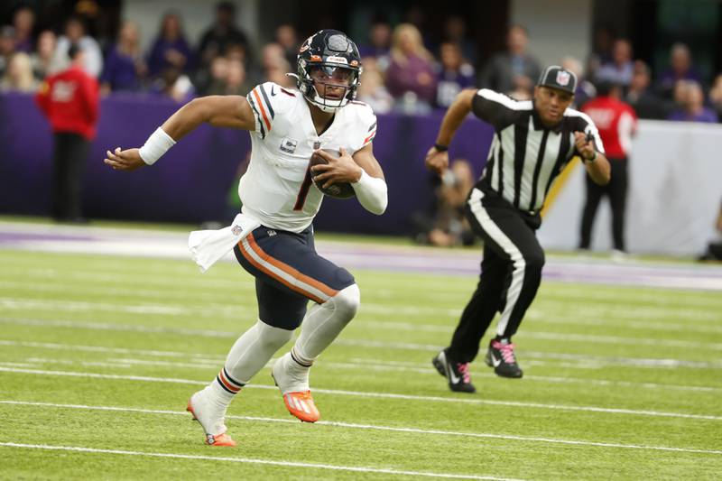Chicago Bears quarterback Justin Fields runs up field during the second half against the Minnesota Vikings, Sunday, Oct. 9, 2022, in Minneapolis.