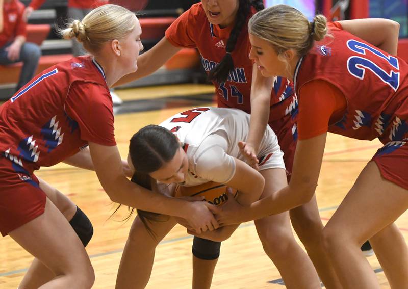 Forreston's Xairyn Goeddeke (5) protects the ball from Morrison's Sophie Damhoff (1) and Avery White (22) during a game at the Forreston High School Girls Basketball Thanksgiving Tournament on Friday, Nov. 21, 2025.