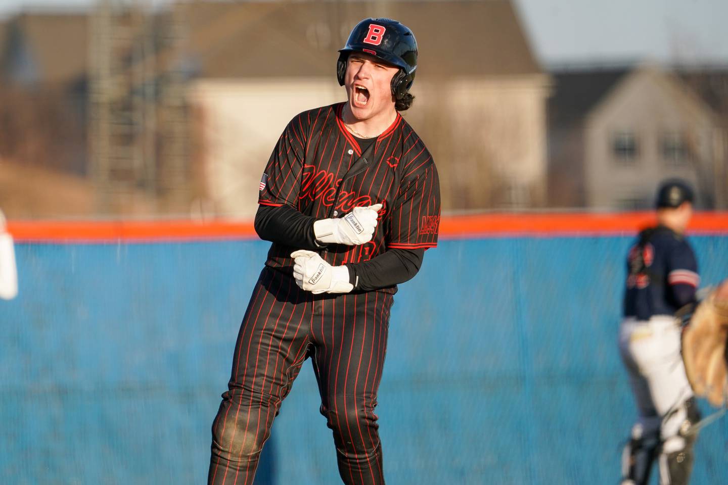 Benet’s Jonathon Rossi (18) reacts after hitting a double against Oswego during a baseball game at Oswego High School on Tuesday, March 25, 2025.